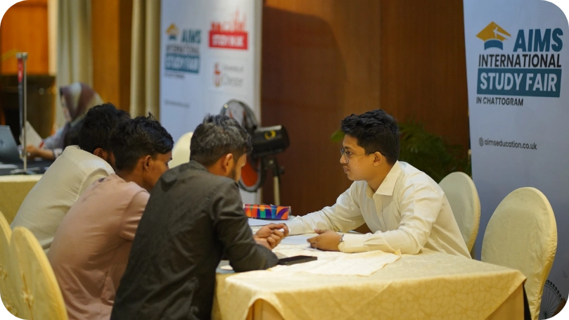 Students receiving guidance and support from a counselor at a study abroad education expo